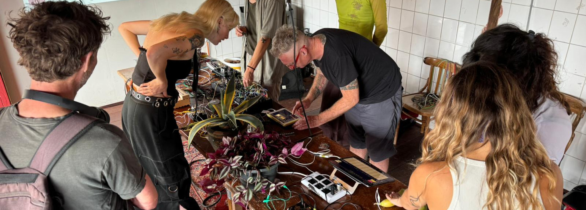 People around a table making sounds with plants and heartbeats